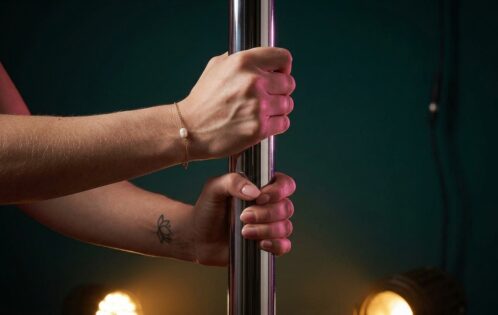 Dancer's hands gripping a pole — pole dancer injury prevention conditioning focus