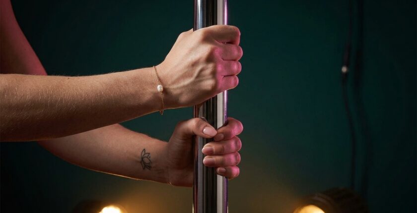 Dancer's hands gripping a pole — pole dancer injury prevention conditioning focus